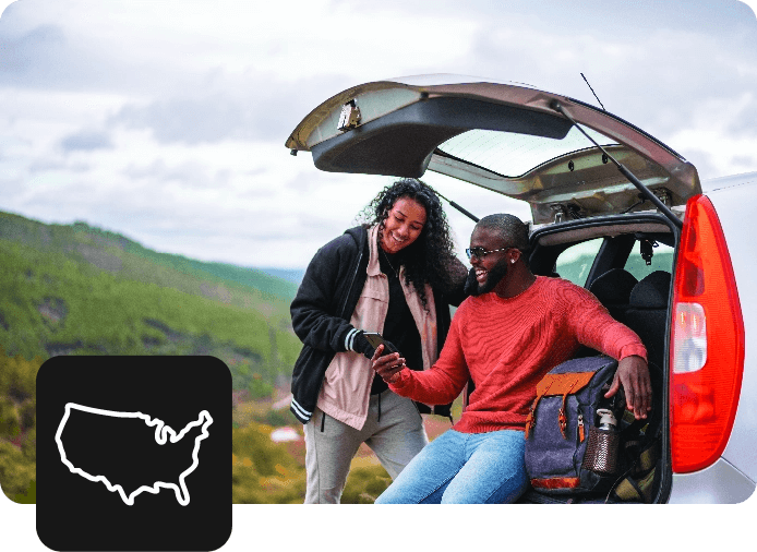 Two people sitting on back of car